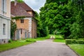 A traditional old manor house in the countryside with a road leading into the distance. Royalty Free Stock Photo