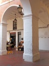 The traditional old market square in ciutadella menorca with a vegetable shop behind the pillars and arches
