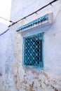 Traditional old painted blue window with ornament decorative forging in historical district or Medina of Tunis, Tunisia.