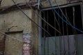 Traditional old window on brick wall with electrical cables