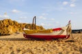 Traditional old wooden fishing boat on the rocky beach. Travel concept. Costa Brava, Spain. Fishing boat rest on golden sand beach Royalty Free Stock Photo