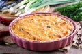 Traditional onion cheese quiche on wooden table. Horizontal