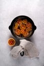 Traditional orange sauce for French crepe Suzette in a cast iron pan on light table.Flat lay, top view, copy space Royalty Free Stock Photo