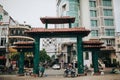 traditional oriental gates and modern buildings on street of Ho Chi Minh, Vietnam