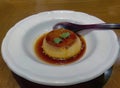 Traditional original style vanilla caramel custard pudding with burnt caramel sauce serving in a white plate, Japanese restaurant