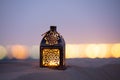 Traditional ornamental arabic candle in desert.