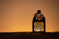 Traditional ornamental arabic candle in desert.