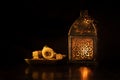 Traditional ornamental arabic candle in dark light.
