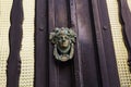 Traditional ornate door handle or knocker against a wooden door Royalty Free Stock Photo