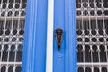 Traditional ornate door handle or knocker against a wooden door Royalty Free Stock Photo