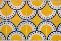 Traditional ornate portuguese decorative tiles azulejos on a building facade - close up photo in yellow, blue and white colors Royalty Free Stock Photo