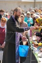 Traditional orthodox paschal ritual - priest blessing easter egg