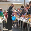 Traditional orthodox paschal ritual - priest blessing easter egg