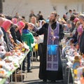 Traditional orthodox paschal ritual - priest blessing easter egg