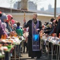 Traditional orthodox paschal ritual - priest blessing easter egg