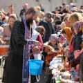 Traditional orthodox paschal ritual - priest blessing easter egg