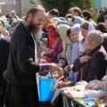 Traditional orthodox paschal ritual - priest blessing easter egg