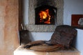 Traditional outdoor firewood oven. Burning flames in fireplace and tools in the foreground