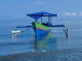 Traditional outrigger boat with a tranquil scene on Morowali beach Royalty Free Stock Photo