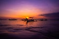 Traditional outrigger fishing boats silhouetted against a sunset, Bali Indonesia Royalty Free Stock Photo