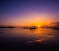 Traditional outrigger fishing boats silhouetted against a sunset, Bali Indonesia Royalty Free Stock Photo