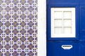 Painted tiles and matching blue color entrance door to the building in Lisbon