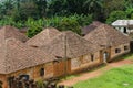 Traditional palace of the Fon of Bafut with brick and tile buildings and jungle environment, Cameroon, Africa Royalty Free Stock Photo