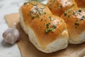 Traditional pampushka buns with garlic and herbs on white table, closeup Royalty Free Stock Photo