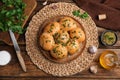Traditional pampushka buns with garlic and herbs on wooden table, flat lay Royalty Free Stock Photo