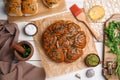 Traditional pampushka rolls with garlic and herbs on white wooden table, flat lay Royalty Free Stock Photo