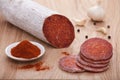 Traditional paprika salami on board with garlic