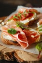 Traditional parma cured ham antipasto. Bruschetta set with Parma Ham and Parmesan Cheese. Small sandwiches with prosciutto,