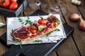 Traditional parma cured ham antipasto on wooden background, rustic style