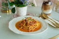 Traditional pasta spaghetti bolognese in white plate on pink table background. Appetizing spaghetti rolled with typical Italian Royalty Free Stock Photo