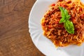 Pasta spaghetti bolognese in white plate on wooden table background Royalty Free Stock Photo