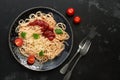 Traditional pasta spaghetti with tomato sauce, parmesan cheese and greens on a black stone background. Overhead , flat lay,copy Royalty Free Stock Photo