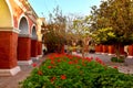 Colorful colonial arch with flowers in the patio Royalty Free Stock Photo