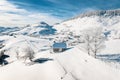 Traditional Peasant houses covered in snow after a heavy snowfall in the Carpathian Mountains