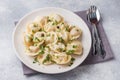 Traditional pelmeni, ravioli, dumplings filled with meat on plate, russian kitchen