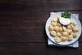 Traditional pelmeni, ravioli, dumplings filled with meat on plate, russian kitchen. Wooden rustic background, copy space Royalty Free Stock Photo