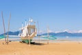 Traditional philippine boat called bangka on the beach. Fishing boat on seacoast in Asia on sunny day. Tropical lagoon.