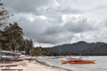 Traditional Philippine fisherman boats docked on a beach in a lagoon in Port Barton Palawan Island the Philippines before a storm