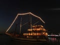 Traditional Phinisi Ship Illuminated at Night in Makassar, Indonesia Royalty Free Stock Photo