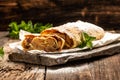 Traditional piece of apple strudel with powdered sugar and mint closeup on a wooden background. copy space Royalty Free Stock Photo