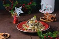 Traditional Polish Christmas dish, noodles with poppy seeds, raisins, candied fruits and sliced almonds on a red plate on a brown Royalty Free Stock Photo