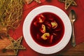 Traditional Polish christmas soup - red borscht soup with dumplings on white plate. Royalty Free Stock Photo