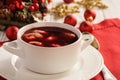 Traditional Polish christmas soup - red borscht soup with dumplings on white plate. Royalty Free Stock Photo