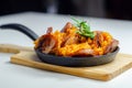 Traditional Polish dish called bigos made of sauerkraut, sausage and mushrooms, food served warm in a cast iron pan Royalty Free Stock Photo