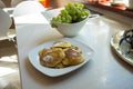 Traditional Polish pancakes on a plate and green grapes on a kitchen counter