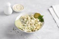 Traditional polish salad with apple, pickled cucumber, onion and mayonnaise on a light gray background